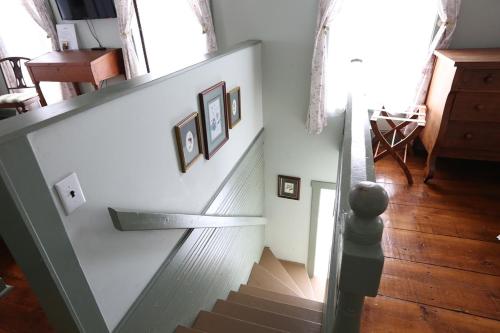 a staircase in a home with two pictures on the wall at The Lafayette Inn & Restaurant in Stanardsville
