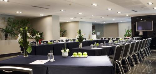 a row of tables and chairs in a room at Mövenpick Hotel Casablanca in Casablanca