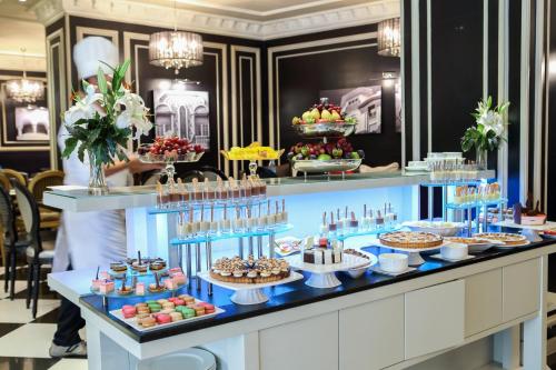 a buffet line with desserts and pastries on display at Mövenpick Hotel Casablanca in Casablanca