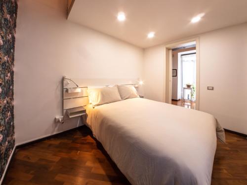 a bedroom with a large white bed and a window at Zagara Luxury Home in Catania