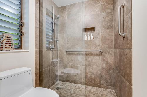 a bathroom with a shower with a toilet at Wailea Ekolu Village - CoralTree Residence Collection in Wailea