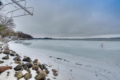 a frozen river with a rock wall and snow at Family-Friendly Lake Waubesa Home Boat and Swim! in McFarland