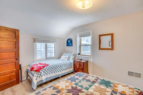 a bedroom with a bed and a dresser and window at Family-Friendly Lake Waubesa Home Boat and Swim! in McFarland