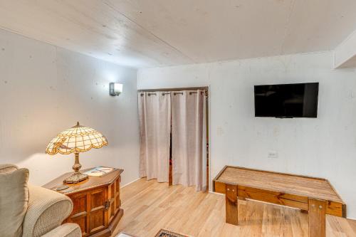 a living room with a couch and a table and a tv at Family-Friendly Lake Waubesa Home Boat and Swim! in McFarland