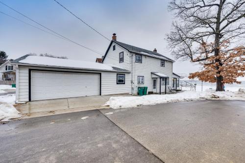 a large white house with a garage at Family-Friendly Lake Waubesa Home Boat and Swim! in McFarland