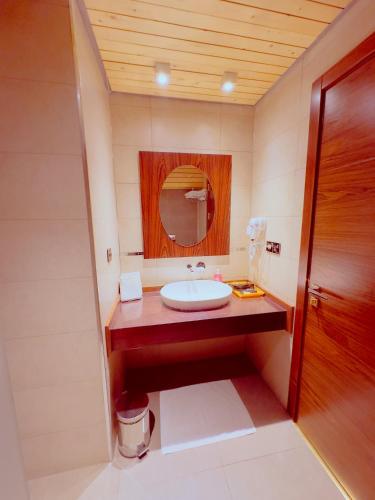 a bathroom with a sink and a mirror at Granada Hotel in An Najaf