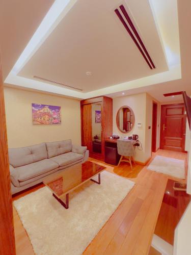 a living room with a couch and a table at Granada Hotel in An Najaf