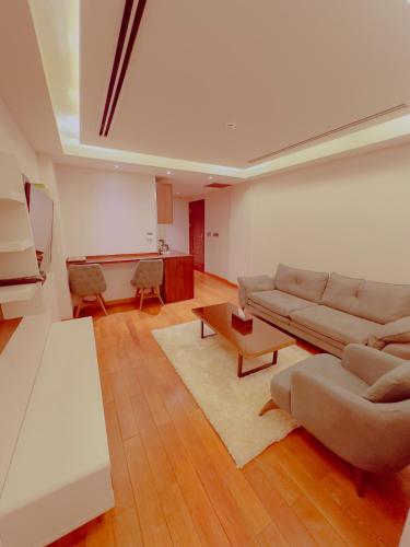 a living room with a couch and a table at Granada Hotel in An Najaf