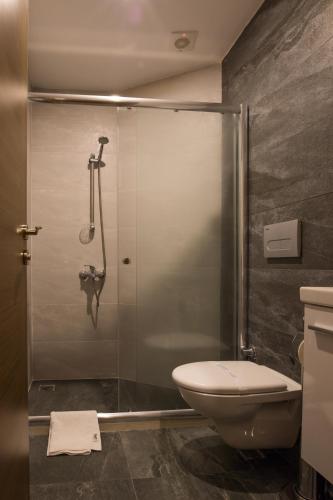 a bathroom with a glass shower with a toilet at Manzara Hotel in Eskisehir