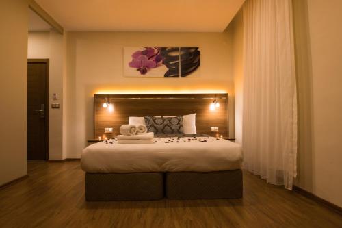 a bedroom with a large bed with two towels on it at Manzara Hotel in Eskisehir