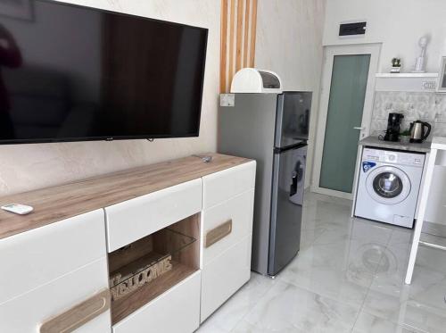 a living room with a large flat screen tv at Sunny Dreams in Nea Kalikratia