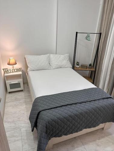 a bedroom with a bed in a room with a mirror at Sunny Dreams in Nea Kalikratia