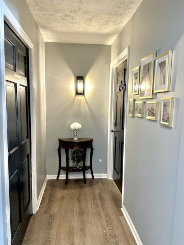 a hallway with a table next to a door at Speedway Legacy Inn in Indianapolis
