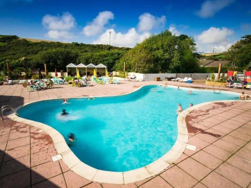 a large swimming pool with people in it at 11 Meadow View in Newquay