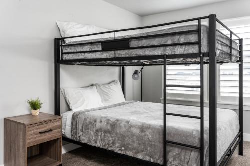 ein Schlafzimmer mit einem Etagenbett und einem Schreibtisch in der Unterkunft 8 Beds 2 Full Kitchens Fenced HUGE Yard & Parks! in Saratoga Springs