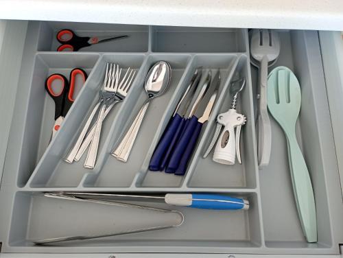 a drawer filled with utensils and scissors at Il Portico Rosa in Cuglieri