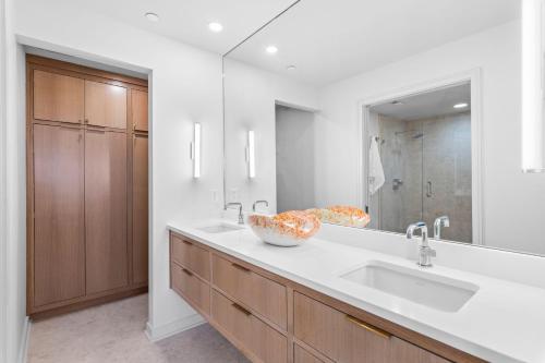 a bathroom with two sinks and a large mirror at High Pointe Resort 414 in Rosemary Beach