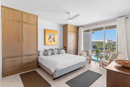 a bedroom with a bed and a large window at High Pointe Resort 414 in Rosemary Beach