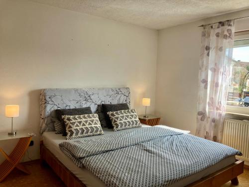 a bedroom with a bed with two pillows and a window at Casa Pippi Lotta in Gießen
