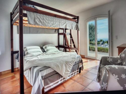 a bedroom with a bunk bed and a chair at Maison de 4 chambres avec piscine privee jacuzzi et jardin clos a Aspremont in Aspremont
