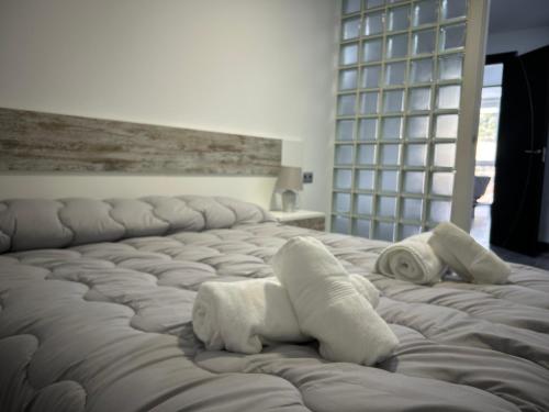 a bedroom with two beds with towels on them at Apartamento Verdial 2 in Cala del Moral