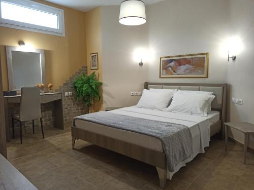 a bedroom with a bed and a table and a mirror at Zeusplace Olympous Riviera Villa 1 in Litochoro