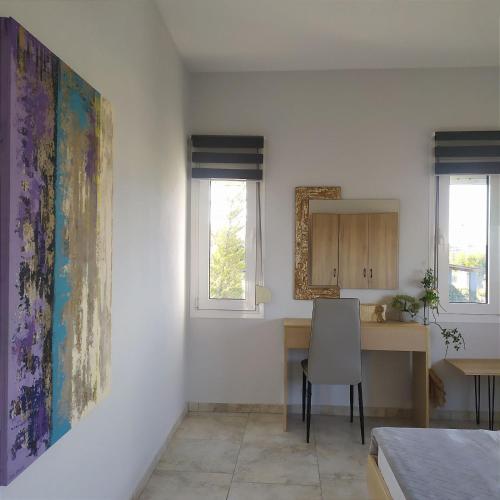 a kitchen with a table and a chair in a room at Zeusplace Olympous Riviera Villa 1 in Litochoro