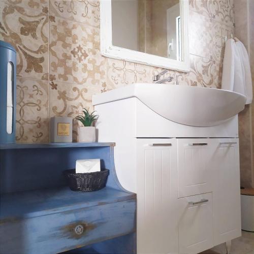 a bathroom with a white sink and a mirror at Zeusplace Olympous Riviera Villa 1 in Litochoro