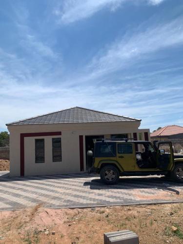 a jeep parked in front of a small house at CasaTurin in Molepolole