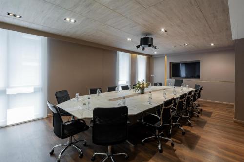 a large conference room with a long table and chairs at Zayn Hotel Bangkok - Airport Link Access in Bangkok