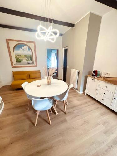 a dining room with a white table and chairs at Casa gioia in Bracciano