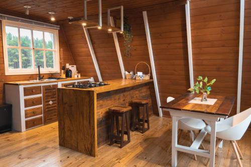 a kitchen with wooden walls and a wooden counter top at Refúgio Fortaleza - Cabana Amora in Cambara do Sul