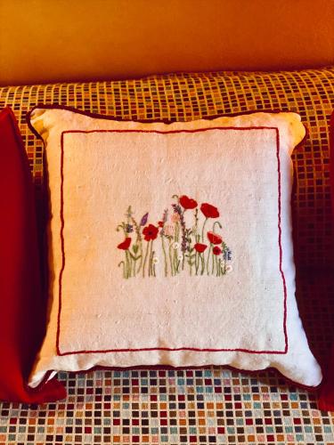 a napkin with a picture of red flowers on it at Dolce Vita in Tuscany B&B in Capannori