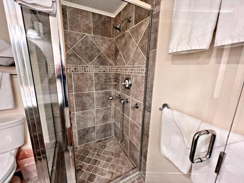 a shower with a glass door in a bathroom at Porpoise Pass in Foley