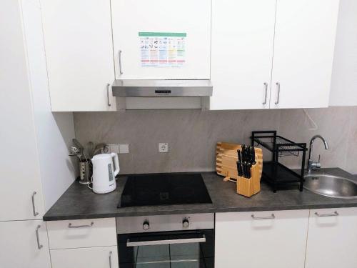 a kitchen with white cabinets and a counter top at L8 Street - Leipziger Straße in Kaiserslautern