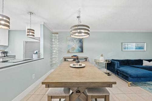 a living room with a table and a blue couch at 2 BR Home in St Andrews, Close to Everything in Panama City