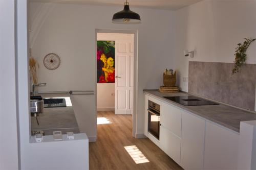 a kitchen with white cabinets and a counter top at Casa de KoKo in Turre