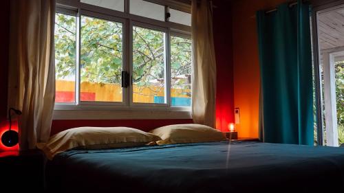 a bedroom with a bed and a large window at Villa Mitirapa in Tohautu