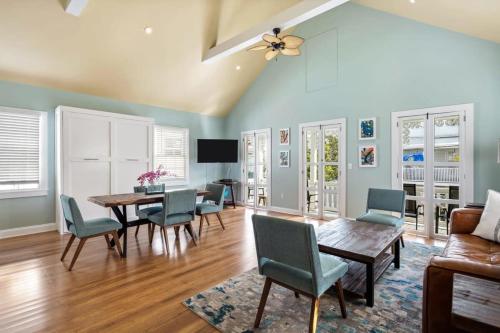 a living room with a table and chairs and a couch at Sky Suite On Duval in Key West