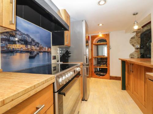 a kitchen with a large painting on the wall at Pebble Bay in Brixham