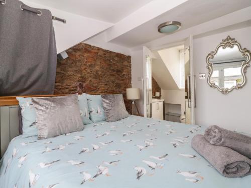 a bedroom with a bed with birds on it at Pebble Bay in Brixham