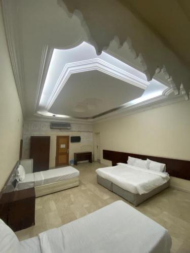 a large bedroom with two beds and a skylight at فندق السمان in Al Madinah