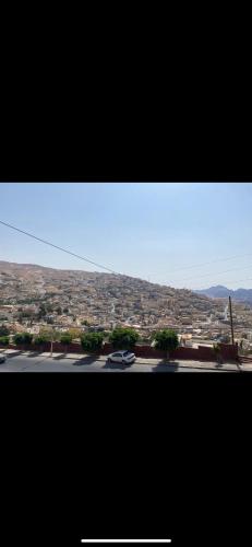 a view of a city with cars on a road at Over Mountains Hotel in Wadi Musa