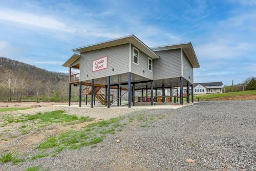 a large building with a large roof at Riverfront Caddo Shack Home with Views and Fire Pit in Glenwood