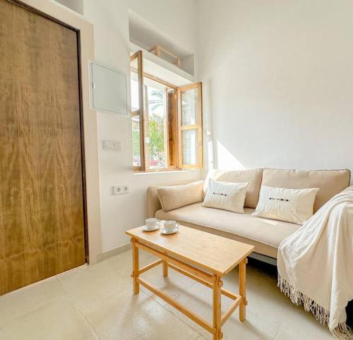 a living room with a couch and a coffee table at An Unbeatable Location in the Very Centre of Ecija in Écija