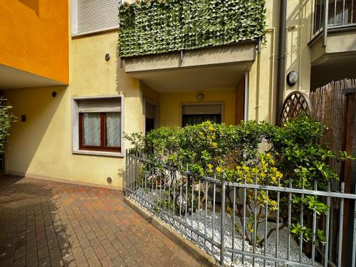 a fence in front of a building with plants at Blue Vacanze in Verona