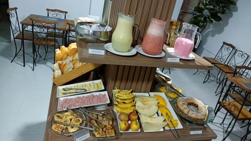 a table filled with lots of different types of food at Let's Go Tour Palace Hotéis in Canaã dos Carajás