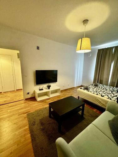 a living room with a couch and a flat screen tv at Cozy And Central Apartment in Gothenburg