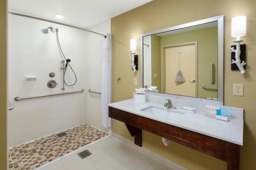 a bathroom with a sink and a shower at Hampton Inn & Suites Williamsport - Faxon Exit in Williamsport