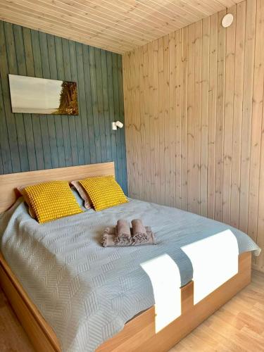 a bedroom with a bed with towels on it at Silazari Klapkalnciems in Klapkalnciems